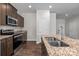 A well-equipped kitchen featuring stainless appliances, granite counters, and modern cabinets at 206 Overstone Ct, Fort Mill, SC 29715