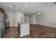 Open kitchen with granite countertops, stainless steel appliances, and hardwood floors at 206 Overstone Ct, Fort Mill, SC 29715