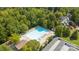 An aerial view showcases a large community pool surrounded by trees and lounge chairs at 206 Overstone Ct, Fort Mill, SC 29715