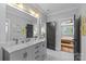 Elegant bathroom featuring double vanity, marble countertops, and stylish gray door at 2615 Chesterfield Ave, Charlotte, NC 28205
