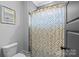 Cozy bathroom boasts a modern shower curtain and sleek gray tiled walls at 2615 Chesterfield Ave, Charlotte, NC 28205