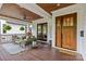 Relaxing front porch featuring comfortable seating, ceiling fan, wood flooring, and double door entry at 2615 Chesterfield Ave, Charlotte, NC 28205