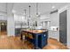 Stylish kitchen features a large wooden island with seating, stainless steel appliances, and ample storage space at 2615 Chesterfield Ave, Charlotte, NC 28205