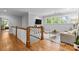 Bright landing area with hardwood floors, a view of trees, and a comfortable sofa at 2615 Chesterfield Ave, Charlotte, NC 28205