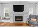 Living room showcasing a modern fireplace, built-in seating, and ample natural light from large windows at 2615 Chesterfield Ave, Charlotte, NC 28205
