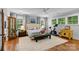Bright, spacious main bedroom with natural light, a Peloton, and hardwood floors at 2615 Chesterfield Ave, Charlotte, NC 28205
