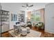 Well-lit home office featuring a modern desk, a bookshelf, and comfortable seating at 2615 Chesterfield Ave, Charlotte, NC 28205