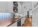Pantry featuring custom cabinetry, wine storage, tile backsplash, and ample countertop space at 2615 Chesterfield Ave, Charlotte, NC 28205