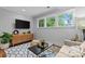 Inviting sitting area with a TV, hardwood floors, and large windows that provide natural light at 2615 Chesterfield Ave, Charlotte, NC 28205