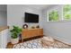 Comfortable sitting area with hardwood floors, natural light, and a TV at 2615 Chesterfield Ave, Charlotte, NC 28205