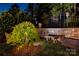 Backyard garden area has stone walls, and a weeping tree near a bench at 2630 Mary Butler Way, Charlotte, NC 28226