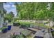 Outdoor living space featuring patio seating, landscaping, and mature trees at 2630 Mary Butler Way, Charlotte, NC 28226