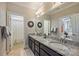 Dual granite sink bathroom with stylish lighting, cabinetry and decorative mirrors at 2630 Mary Butler Way, Charlotte, NC 28226