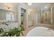 Bright bathroom featuring double sinks, soaking tub, and seamless glass shower at 2630 Mary Butler Way, Charlotte, NC 28226