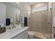 Bathroom featuring a marble countertop vanity and a tiled shower with glass doors at 2630 Mary Butler Way, Charlotte, NC 28226
