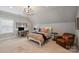 Cozy bedroom with a decorative chandelier, desk, and comfortable seating at 2630 Mary Butler Way, Charlotte, NC 28226