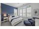 Bright bedroom with a large window, plush rug, and blue accent wall at 2630 Mary Butler Way, Charlotte, NC 28226