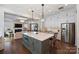 Beautiful, updated kitchen with a large island, stainless steel appliances and hardwood floors at 2630 Mary Butler Way, Charlotte, NC 28226