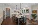 Spacious kitchen features a large island with seating, custom cabinets, modern lighting, and hardwood floors at 2630 Mary Butler Way, Charlotte, NC 28226