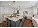 Modern kitchen with large island, white cabinets, stainless steel appliances, and elegant pendant lighting at 2630 Mary Butler Way, Charlotte, NC 28226