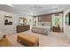 Bright and airy bedroom features a trey ceiling, ensuite access and neutral color palette at 2630 Mary Butler Way, Charlotte, NC 28226