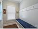 Mudroom with beadboard paneling, hooks, storage cubbies and bench with blue cushion at 2630 Mary Butler Way, Charlotte, NC 28226