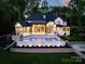 Aerial view of the home featuring a luxury pool, patio, and immaculately landscaped backyard at 301 Riverwood Rd, Mooresville, NC 28117