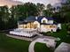 Aerial view of home featuring an inground pool, spacious patio, and lush landscaping at 301 Riverwood Rd, Mooresville, NC 28117