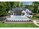 Beautiful backyard showcasing a luxurious pool, outdoor seating area and manicured lawn at 301 Riverwood Rd, Mooresville, NC 28117