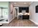Elegant bar area includes custom cabinetry, sleek countertops, a wine cooler, and stylish modern finishes at 301 Riverwood Rd, Mooresville, NC 28117
