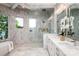 Stunning bathroom showcasing dual vanities, a glass enclosed shower and free standing tub next to view filled windows at 301 Riverwood Rd, Mooresville, NC 28117