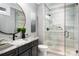 Bathroom boasts a stylish vanity with granite countertop and a tiled glass-enclosed shower at 301 Riverwood Rd, Mooresville, NC 28117