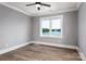 This lovely bedroom features hardwood floors, crown moulding, and a large window with water views at 301 Riverwood Rd, Mooresville, NC 28117