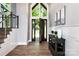 Welcoming entryway with wood floors, stairway, large windows, and attractive decor at 301 Riverwood Rd, Mooresville, NC 28117