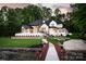 Stunning waterfront home features a manicured lawn and a private dock with lake access at 301 Riverwood Rd, Mooresville, NC 28117