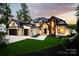 Stunning modern home featuring a beautiful blend of wood and stone accents and a well manicured lawn at 301 Riverwood Rd, Mooresville, NC 28117