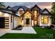 Beautiful exterior of home featuring professionally landscaped grounds and a covered front porch at 301 Riverwood Rd, Mooresville, NC 28117