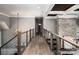 Hallway boasts wood floors, stone accent wall, and decorative lighting creating an inviting, sophisticated atmosphere at 301 Riverwood Rd, Mooresville, NC 28117