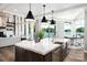 Gourmet kitchen featuring stainless appliances, large island, and picturesque lake views at 301 Riverwood Rd, Mooresville, NC 28117