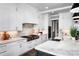 Spacious kitchen with white cabinetry, marble backsplash, and stainless steel appliances at 301 Riverwood Rd, Mooresville, NC 28117