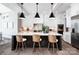 Bright kitchen with stainless steel appliances, marble countertops, and stylish wooden chairs at the island at 301 Riverwood Rd, Mooresville, NC 28117