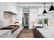 Spacious kitchen with white cabinetry, marble backsplash, and stainless steel appliances at 301 Riverwood Rd, Mooresville, NC 28117