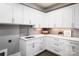 Functional laundry room featuring white cabinetry, ample counter space, and modern fixtures for efficient chores at 301 Riverwood Rd, Mooresville, NC 28117