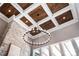Stunning living room featuring a modern chandelier and a coffered ceiling with wooden panels at 301 Riverwood Rd, Mooresville, NC 28117