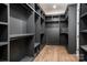 Spacious walk-in closet boasts custom shelving and storage solutions, enhancing organization and maximizing wardrobe space at 301 Riverwood Rd, Mooresville, NC 28117