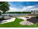 Lakeside property featuring a beautifully landscaped yard, a fire pit and a private boat dock at 301 Riverwood Rd, Mooresville, NC 28117