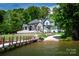 Lakefront property with a modern home, lush lawn, and private dock for boating and recreation at 301 Riverwood Rd, Mooresville, NC 28117