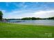 Beautiful waterfront property featuring a private dock and expansive green lawn at 301 Riverwood Rd, Mooresville, NC 28117