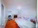 Comfortable bedroom with two beds, fireplace, light walls and hardwood flooring at 3016 Boston Ave, Charlotte, NC 28212