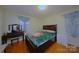 Bedroom features wood floors, a large bed, and plenty of natural light at 3016 Boston Ave, Charlotte, NC 28212